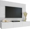 A modern white media console with a large black television mounted on a textured white wall panel. Decorative items and a media player are placed on the console. Náhled obrázku produktu
