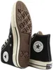 A pair of black Converse Chuck 70 high-top sneakers shown from a low angle, with one shoe's sole prominently displayed. Voir les images du produit