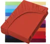 A stack of colorful fitted sheets, with the top one in rust red prominently displayed. Produktbild-Vorschau