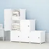 A modular storage unit with white cubes, some open and containing folded fabrics, set against a light blue wall. Anteprima dell’immagine prodotto