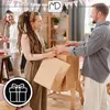 People at a party exchanging gift bags. Produktbild-Vorschau