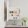 A white medicine cabinet with an open door, displaying various toiletries and bottles on its shelves, mounted above a sink with a faucet. Anteprima dell’immagine prodotto