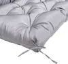 A close-up of a gray tufted cushion with ties. Voir les images du produit