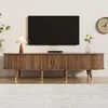 A modern living room with a TV stand, TV, lamp, and clock. Anteprima dell’immagine prodotto