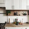 A kitchen counter with a blender, fruits, and a bottle of milk. Produktbild-Vorschau