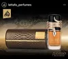 A perfume bottle and its case, both with a snake-skin texture, are displayed against a dark, textured background. A golden snake wraps around the perfume bottle. Podgląd zdjęcia produktu