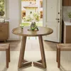 A round wooden dining table with two stools in a bright room with an open doorway leading to a sunny backyard. Anteprima dell’immagine prodotto