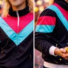 A collage of two close-up shots of a person wearing a colorful tracksuit. Anteprima dell’immagine prodotto