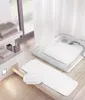 A bathroom scene with bath mats and towels. Produktbild-Vorschau