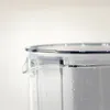 Close-up of the top of a clear plastic pitcher with a lid, showing a pour spout and water droplets on the inside. Produktbild-Vorschau