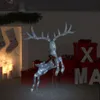 A lighted Christmas reindeer decoration is displayed in a festive setting with stockings hung by a fireplace and gift boxes. Produktbild-Vorschau