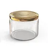 A clear, studio shot of an empty glass jar with a gold lid, presented on a white background. Voir les images du produit