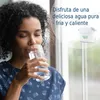 A woman is drinking water from a glass, with a water filter cartridge visible in the background. Náhled obrázku produktu