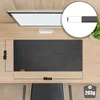 A desk mat is shown on a wooden desk with a monitor in the background. Produktbild-Vorschau