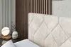 A close-up view of a modern bedroom interior, focusing on the headboard of a bed and a bedside table with a lamp and vase. Produktbild-Vorschau
