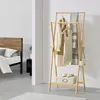 A bedroom scene with a bed and a clothing rack. Náhled obrázku produktu
