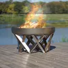 A fire pit on a wooden deck next to a body of water with trees in the background. Produktbild-Vorschau