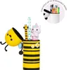 A cute bee-shaped pencil case is open, revealing stationery inside. A circular inset shows a white pencil holder filled with pens. Voir les images du produit