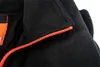Close-up of a black fleece sweatshirt with an orange zipper. Podgląd zdjęcia produktu