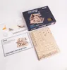 A flat lay of a wooden model kit, assembly instructions, and packaging for a marble run. Podgląd zdjęcia produktu