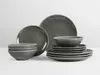 A set of grey ceramic plates and bowls are arranged on a white background. Produktbild-Vorschau