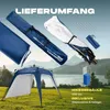 A pop-up pavilion set up in a grassy field with a lake and mountains in the background, along with various components of the pavilion laid out. Voir les images du produit