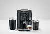 A black JURA coffee machine with two accessories and a cup of coffee on a white background. Anteprima dell’immagine prodotto