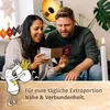 A couple is sitting on a couch, looking at an open advent calendar. There is a candle lit in the background. Produktbild-Vorschau