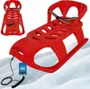 A red plastic sled with a rainbow-colored safety strap and a black pull rope with a handle, resting on a snowy surface. Voir les images du produit