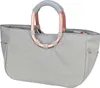 A studio shot of a grey tote bag with rose gold handles. Podgląd zdjęcia produktu