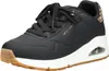 A black Skechers sneaker with a white sole and brown accents. Voir les images du produit