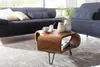 A living room scene with a dark blue sectional sofa and a wooden coffee table. Produktbild-Vorschau