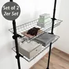 A black wire shelving unit with three shelves, holding various items like boxes, gloves, and folded fabrics. Náhled obrázku produktu