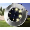 A solar-powered garden light is shown in a yard setting, with a house in the background. Anteprima dell’immagine prodotto