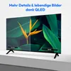 A split-screen image on a TV screen showing a comparison between 'Standard' and 'QLED' picture quality, with text overlay. Produktbild-Vorschau