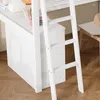 A close-up view of a white loft bed with a desk and ladder, set against a wooden floor. Náhled obrázku produktu