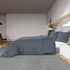 A bedroom scene with a bed made with anthracite bedding. Náhľad obrázku produktu