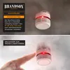A split image showing a smoke detector on a ceiling and a finger pressing its test button, with smoke effects. Produktbild-Vorschau