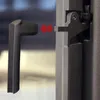 A close-up view of a metal handle mechanism, possibly for a fireplace insert or a similar appliance, with red arrows indicating movement. Anteprima dell’immagine prodotto