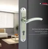 A close-up of a door handle on a dark door, with a blurred interior scene in the background. Produktbild-Vorschau