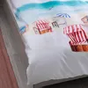 A close-up view of a duvet cover with a beach scene print. Produktbild-Vorschau