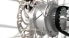 A close-up view of a bicycle hub with spokes and a belt drive system. Anteprima dell’immagine prodotto