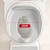 A top-down view of a child's toilet seat insert with a footrest below. Produktbild-Vorschau