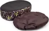 A brown and patterned oval dog bed with a separate cushion, shown on a white background. Produktbild-Vorschau