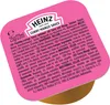 A close-up of a single-serving Heinz Curry Mango Sauce pot with its lid on. Produktbild-Vorschau