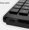 Close-up of a black wireless numeric keypad, showing the power switch and some of the keys. Podgląd zdjęcia produktu