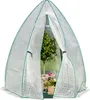 A greenhouse tent with a small tree and potted plants inside. Produktbild-Vorschau