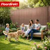 A family and their dog enjoying a sunny day in a garden with a fence. Produktbild-Vorschau