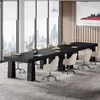 A modern conference room with a large black table and chairs, overlooking a city skyline. Podgląd zdjęcia produktu