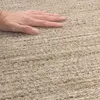 A hand is shown resting on a textured carpet. Produktbild-Vorschau